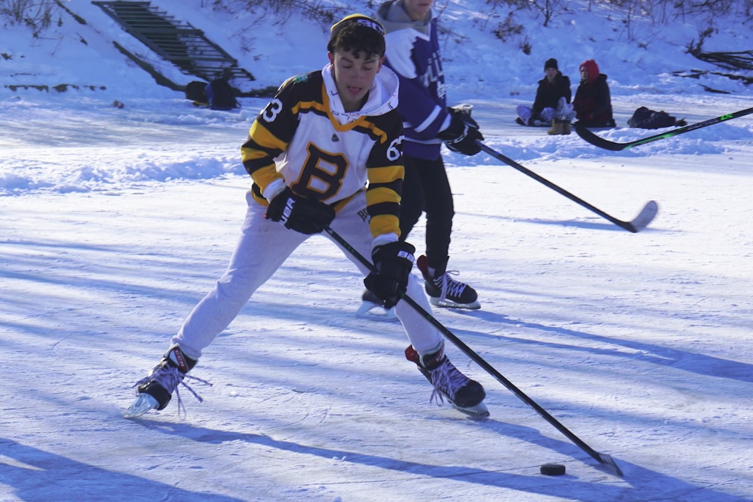 a-group-of-people-playing-a-game-of-ice-hockey-3nw8ydczdh4