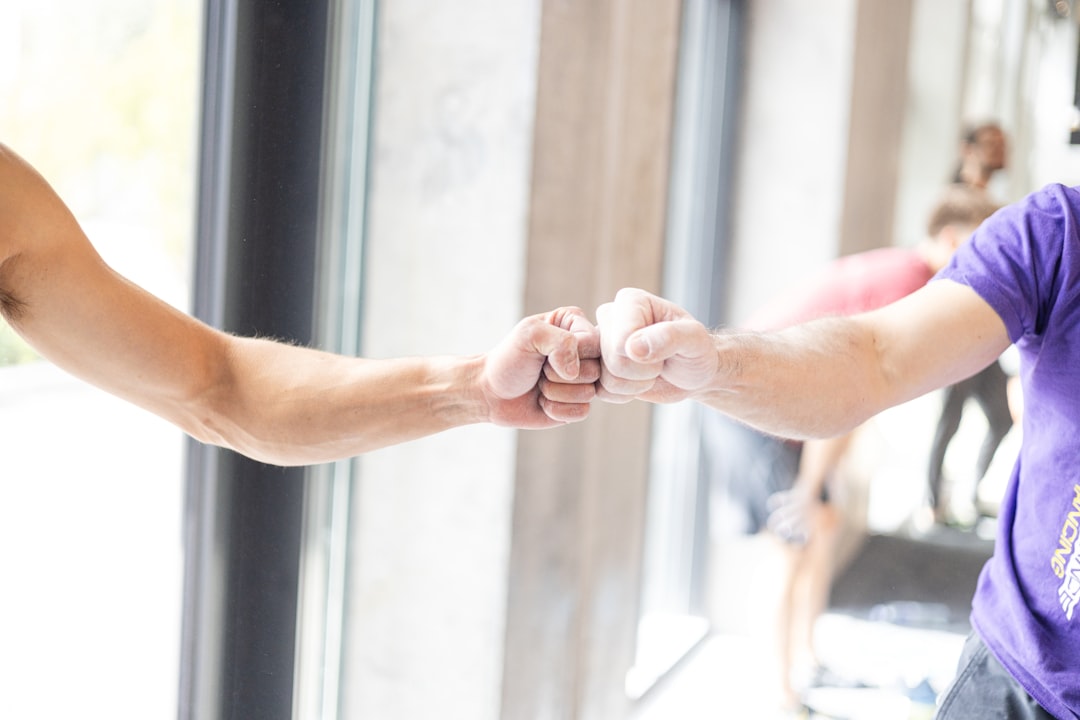 two-people-fist-bumping-in-a-gym-r0gwk7zb19e